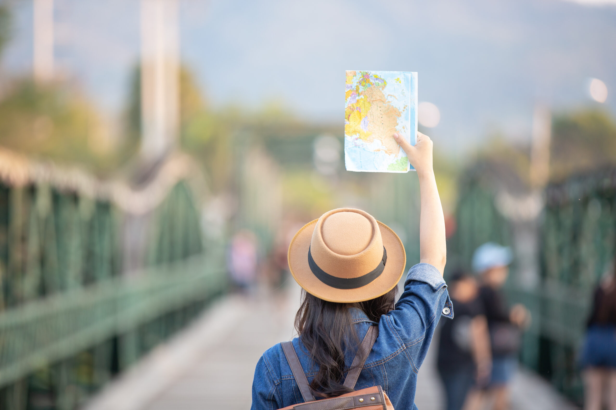 female tourists hand have happy travel map scaled